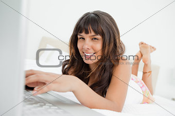 Portrait of a young woman chatting on a laptop