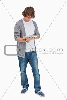 Happy male student using a touch pad