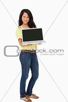 Beautiful Latin student showing a laptop screen