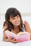 Smiling young woman holding a book