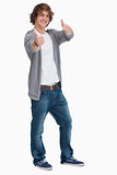Smiling male student posing the thumbs-up