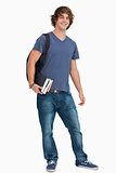 Portrait of a male student with a backpack holding books