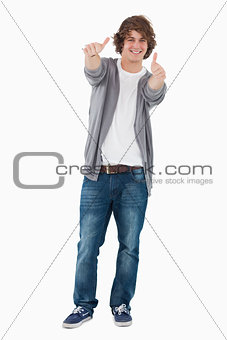 Happy male student posing the thumbs-up
