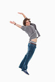 Happy male student posing by jumping