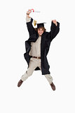 Male student in graduate robe jumping