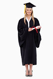 Smiling blonde student in graduate robe holding her diploma