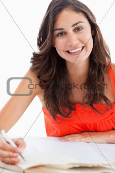 Portrait of a smiling student doing her homework