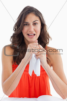 Portrait of a upset student tearing her homeworks