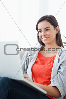 A close up shot of a woman using her laptop 