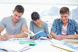 Three students study hard together