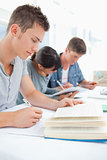 Close up of three students studying hard