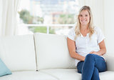A woman sitting on the couch smiling