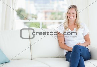 A woman sitting on the couch smiling