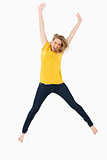 Young blonde woman in yellow shirt jumping