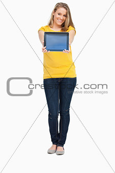 Blonde woman smiling while showing a touch pad screen