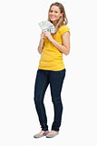 Blonde woman smiling while holding a lot of dollars