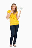 Beautiful blonde woman smiling while showing a lot of dollars