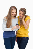 Two females student smiling while looking a cellphone