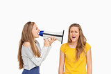 Female student using a loudspeaker on a other girl