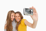 Two students taking a picture of themselves with a digital camer