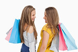 Rear view of two young women with shopping bags