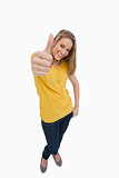 Portrait of a smiling blonde woman the the thumb-up