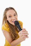 Close-up of a blonde singing with a microphone