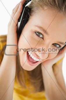 Close-up of a blonde girl enjoying music with headphones