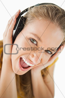 Close-up of a blonde student enjoying music with headphones