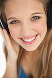 Close-up of a cute young blonde wearing headphones