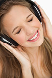 Close-up of a cute young blonde listening to music