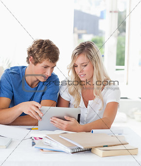 A couple look at a tablet together