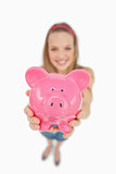 Fisheye view of a young woman tending a piggy-bank
