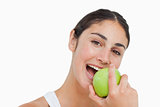 Close-up a brunette eating a green apple