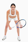 Slim young woman playing tennis in white clothes
