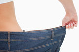 Close-up of a woman waist in a too big pants