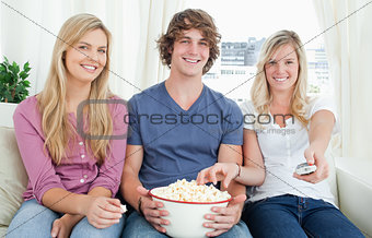 Three friends enjoying popcorn together