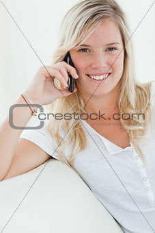 Close up of a woman smiling as she talks on the phone