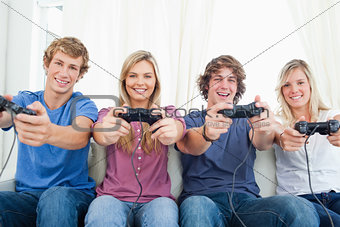 A smiling gang of friends as they look at the camera while gamin
