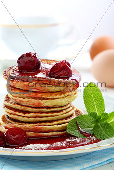 Small pancakes with fruit sauce.