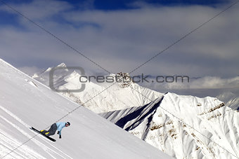 Snowboarder on off-piste slope in mountains