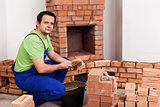 Masonry worker building fireplace