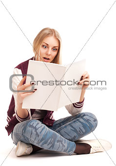 Portrait of a young woman reading magazine