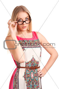 Young woman looking over glasses