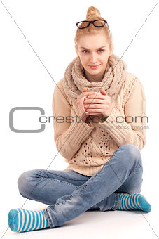 Blond woman holding cup of hot drink