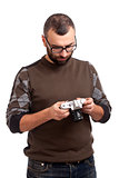 Young man with beard holding photo camera