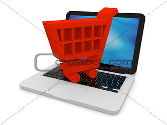 Red shopping trolley on laptop