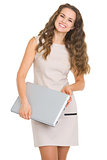 Portrait of smiling young woman with laptop