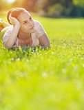 Thoughtful girl laying on meadow