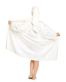 Full length portrait of woman taking off bathrobe. Rear view